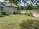Spacious backyard with a well-maintained lawn and a privacy fence, perfect for outdoor activities at 10533 Hazel St, Largo, FL 33778