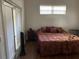 Bedroom featuring hard wood floors and a sliding glass door with a view at 10533 Hazel St, Largo, FL 33778