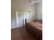 Bedroom featuring hard wood floors and a sliding glass door with a view at 10533 Hazel St, Largo, FL 33778