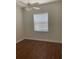 Bedroom featuring hardwood floors, ceiling fan, and a window for natural light at 10533 Hazel St, Largo, FL 33778