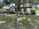 Attractive home featuring a lush lawn, decorative landscaping, and an inviting front exterior at 10533 Hazel St, Largo, FL 33778