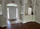 The grand foyer features decorative columns, tile flooring, and a decorative front door with sidelights at 10533 Hazel St, Largo, FL 33778
