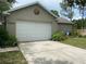 Attached two-car garage with a clean driveway and well-maintained landscaping at 10533 Hazel St, Largo, FL 33778