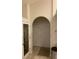Hallway featuring an arched doorway and neutral tile flooring at 10533 Hazel St, Largo, FL 33778