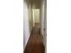 Hallway featuring rich hardwood floors and an inviting archway into another room at 10533 Hazel St, Largo, FL 33778