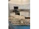 Bright kitchen featuring white cabinets, granite countertops, and stainless steel appliances at 10533 Hazel St, Largo, FL 33778