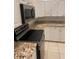 Modern kitchen featuring white cabinets, granite countertops, and stainless steel appliances at 10533 Hazel St, Largo, FL 33778