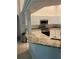 Eat-in kitchen featuring white cabinets, granite countertops, and stainless appliances at 10533 Hazel St, Largo, FL 33778