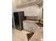 Modern kitchen with stainless steel refrigerator, white cabinets, and granite countertops at 10533 Hazel St, Largo, FL 33778