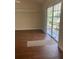 Living room with wood floors and sliding glass doors to the lanai at 10533 Hazel St, Largo, FL 33778