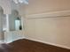 Bright living room with wood floors, decorative columns, and neutral paint at 10533 Hazel St, Largo, FL 33778