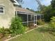 A charming screened patio with lush tropical landscaping around the perimeter offers a peaceful outdoor living space at 10533 Hazel St, Largo, FL 33778