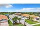 Charming home boasts manicured landscaping, a paved driveway, a two-car garage, and serene community views at 15503 Corona Del Mar Dr, Wimauma, FL 33598
