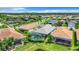A beautiful community showcasing houses with tile roofs, lush landscaping, and a lake backdrop at 15503 Corona Del Mar Dr, Wimauma, FL 33598