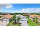 This home features a paved driveway, tropical landscaping, two-car garage, and beautiful community views at 15503 Corona Del Mar Dr, Wimauma, FL 33598