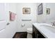 Well-lit half bathroom features a modern vanity, fixtures, and decor at 15503 Corona Del Mar Dr, Wimauma, FL 33598