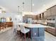 Gourmet kitchen featuring a large island with seating and stainless steel appliances at 15503 Corona Del Mar Dr, Wimauma, FL 33598