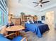 Cozy main bedroom filled with natural light, showcasing wood tile floors, blue accents, and a wooden dresser at 15503 Corona Del Mar Dr, Wimauma, FL 33598