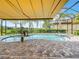 Gorgeous in-ground pool and spa with clear blue water, complemented by lush landscaping for a relaxing outdoor experience at 15503 Corona Del Mar Dr, Wimauma, FL 33598