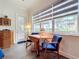 Bright sitting area with wood tile flooring, a round table, and large windows overlooking the outdoors at 15503 Corona Del Mar Dr, Wimauma, FL 33598