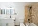 Bright bathroom featuring a white vanity with solid surface top and a tiled shower and tub at 1967 Cormorant Ct # 516, Clearwater, FL 33762