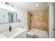 Bright bathroom featuring tiled shower-tub, modern vanity, and updated fixtures at 1967 Cormorant Ct # 516, Clearwater, FL 33762