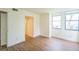 Neutral bedroom with hardwood floors, two windows, and white trim at 1967 Cormorant Ct # 516, Clearwater, FL 33762