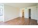 Bedroom with wood-look flooring and a view to an en-suite bathroom at 1967 Cormorant Ct # 516, Clearwater, FL 33762