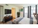 This bedroom features a dresser with a TV, large windows, and gray curtains at 1967 Cormorant Ct # 516, Clearwater, FL 33762