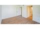 Bright bedroom featuring wood-look flooring, neutral walls, and easy access to the bathroom at 1967 Cormorant Ct # 516, Clearwater, FL 33762