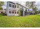 Exterior of condo with screened patio and grassy backyard at 1967 Cormorant Ct # 516, Clearwater, FL 33762