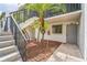 Building exterior featuring well-maintained grounds, stairs, and secure entrance at 1967 Cormorant Ct # 516, Clearwater, FL 33762
