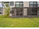 Exterior of condo with screened patio and grassy backyard at 1967 Cormorant Ct # 516, Clearwater, FL 33762