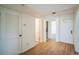 Hallway featuring wood-look floors and several doorways at 1967 Cormorant Ct # 516, Clearwater, FL 33762