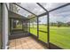 Enclosed patio with tile flooring overlooks a grass lawn at 1967 Cormorant Ct # 516, Clearwater, FL 33762