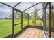 Enclosed patio with tile flooring overlooks a well-maintained lawn at 1967 Cormorant Ct # 516, Clearwater, FL 33762