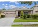 Charming single-story home featuring a manicured lawn, neutral paint, and a two car garage at 20074 Heritage Point Dr, Tampa, FL 33647