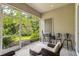 Relaxing screened-in patio featuring an outdoor grill and comfortable seating area overlooking lush greenery at 20074 Heritage Point Dr, Tampa, FL 33647