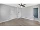 Bedroom with hardwood floors, fresh paint, a ceiling fan, closet, and attached bath at 4928 Stolls Ave, Tampa, FL 33615