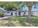 Charming single-story home featuring a manicured lawn, covered entryway, and lovely curb appeal at 4928 Stolls Ave, Tampa, FL 33615