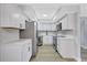 Contemporary kitchen with stainless steel appliances, crisp white cabinetry, and modern hardware at 4928 Stolls Ave, Tampa, FL 33615