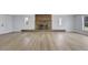 Bright living room featuring a brick fireplace, new flooring, and natural light at 4928 Stolls Ave, Tampa, FL 33615