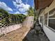 Cozy backyard features a chain link fence and a lush hedge on top of pink block fencing at 5627 Oakland Dr, Tampa, FL 33617