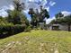 Large green backyard near a house and an outdoor shed with privacy fence at 5627 Oakland Dr, Tampa, FL 33617