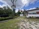An expansive backyard featuring a storage shed and a neatly landscaped lawn at 5627 Oakland Dr, Tampa, FL 33617