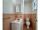 Small bathroom featuring pink tiling and an above counter sink at 5627 Oakland Dr, Tampa, FL 33617