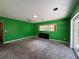 Spacious bedroom features sliding glass doors, ceiling fan, and neutral carpet at 5627 Oakland Dr, Tampa, FL 33617