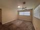 Bedroom with a ceiling fan, natural light from windows, and carpet flooring at 5627 Oakland Dr, Tampa, FL 33617