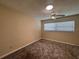 This bedroom features a ceiling fan, neutral walls, and plush carpeting at 5627 Oakland Dr, Tampa, FL 33617