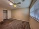 Bedroom featuring a ceiling fan, window with blinds, and closet at 5627 Oakland Dr, Tampa, FL 33617